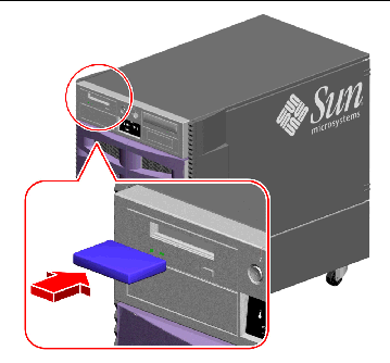 This figure shows where and how to insert a tape cartridge into the Sun Fire V890 server's optional tape drive.