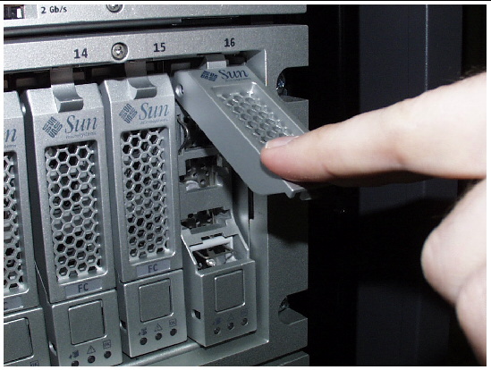 Photograph showing how to press on the drive handle to lock the disk drive in the tray. 