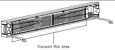 Graphic shows a callout "Vacuum this area" pointing to the screen.