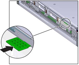 image:The illustration shows pushing the tab under the DVD drive.