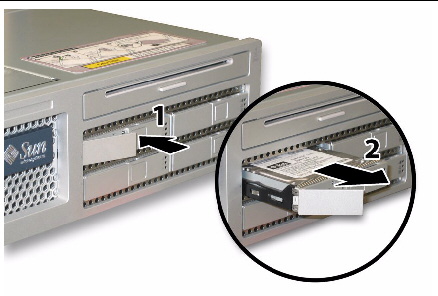 Removing a hard disk drive after pressing the button to release the securing latch.