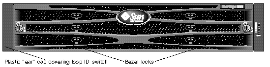 This figure displays the front bezel, bezel locks, and plastic ear cap covering the FC loop ID switch. 