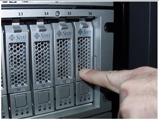 Figure shows a drive completely installed, with the drive and handle flush with the others.Figure shows a drive being inserted into the chassis the correct way by slowly pushing against the drive housing with a forefinger until the drive handle engages with the chassis.