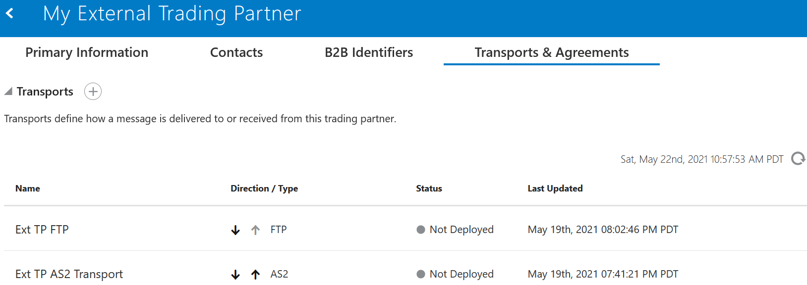 The Primary Information, Contacts, B2B Identifiers, and Transports & Agreements (which is selected) are shown. Below is the Transports section, with a + sign. Below is a table with columns for Name, Direction/Type, Status, and Last Updated.