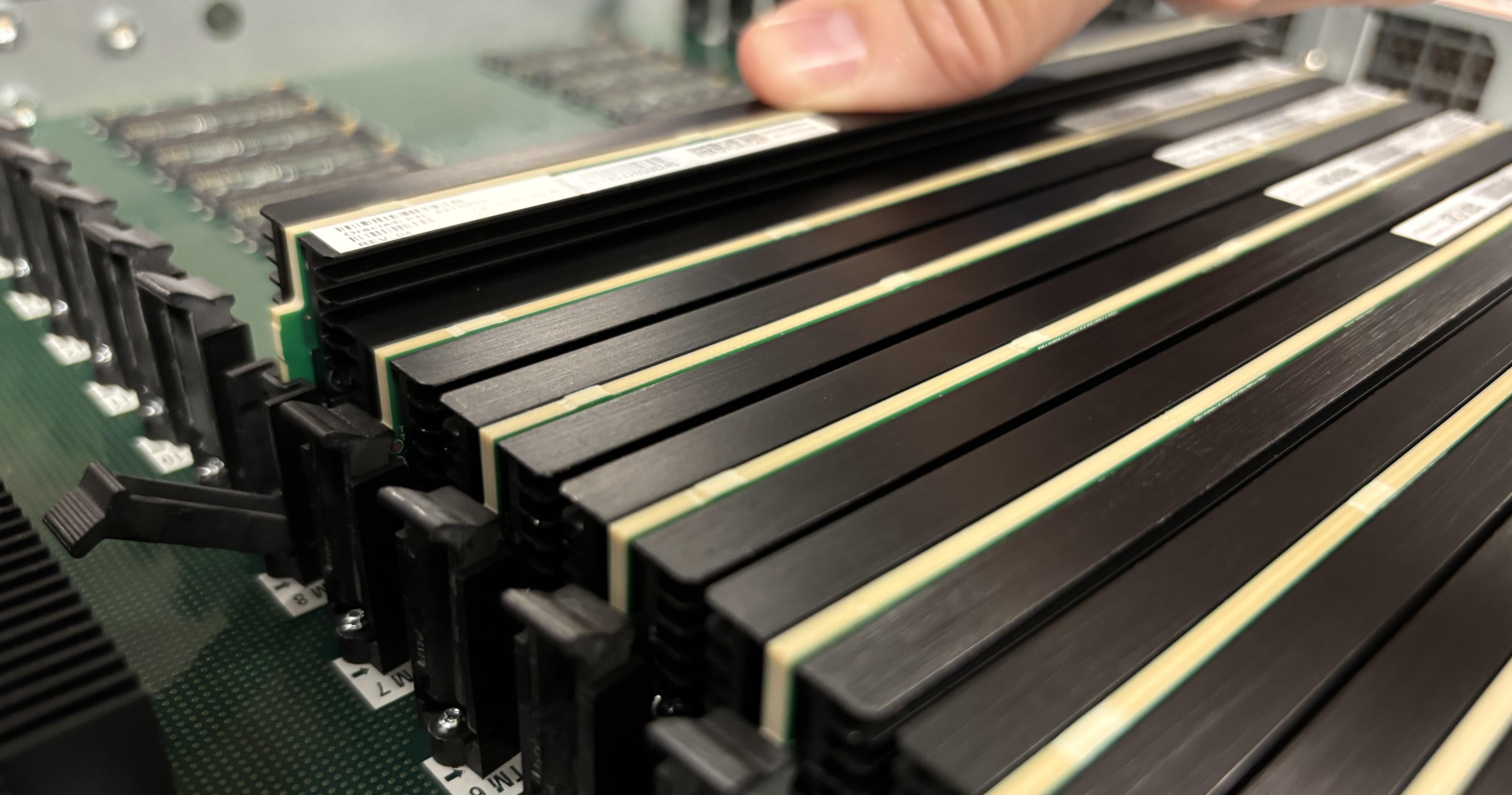 This picture shows someone properly seating the transcoding module.