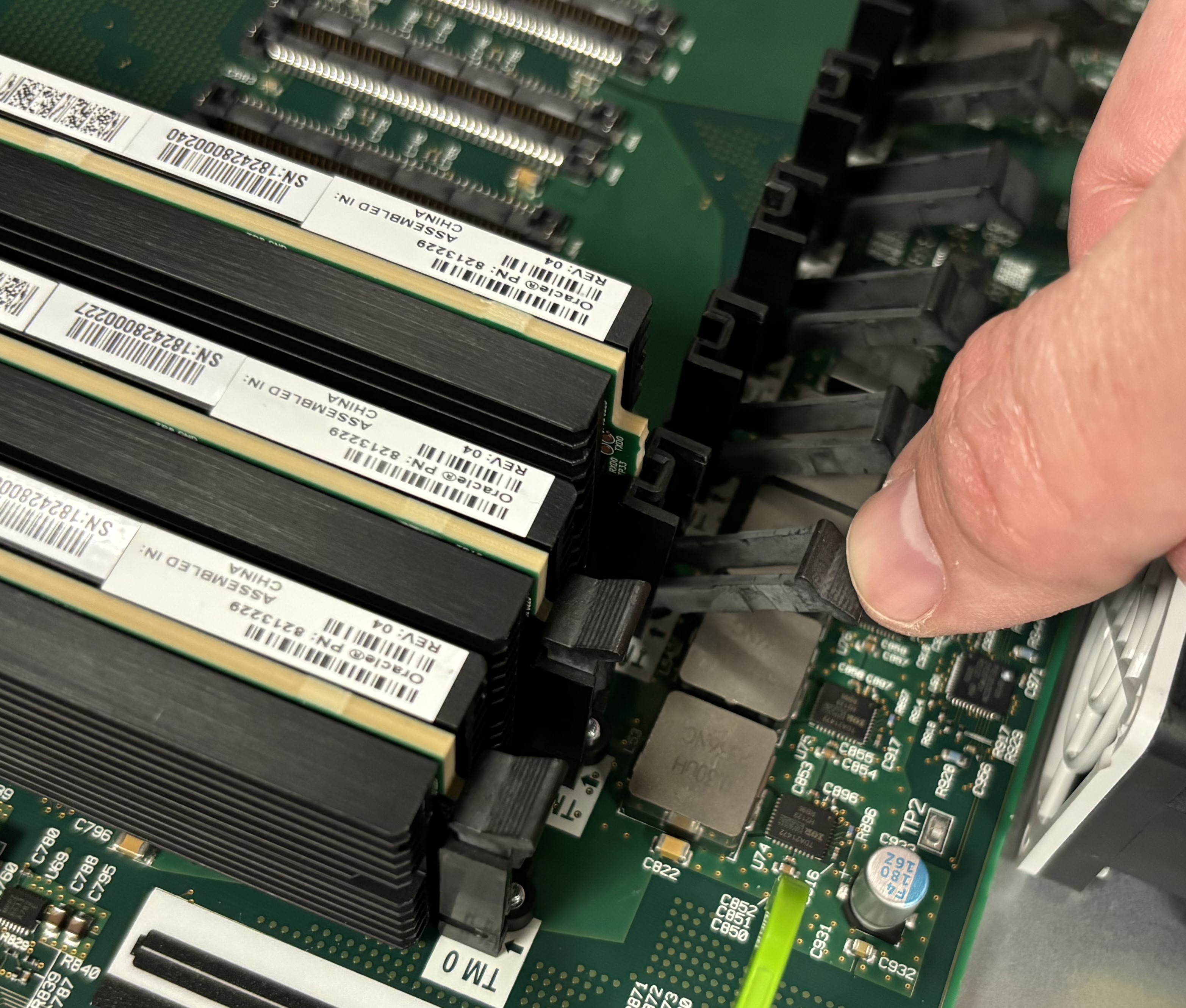 This picture shows someone releasing the latch holding the Transcoding Module.