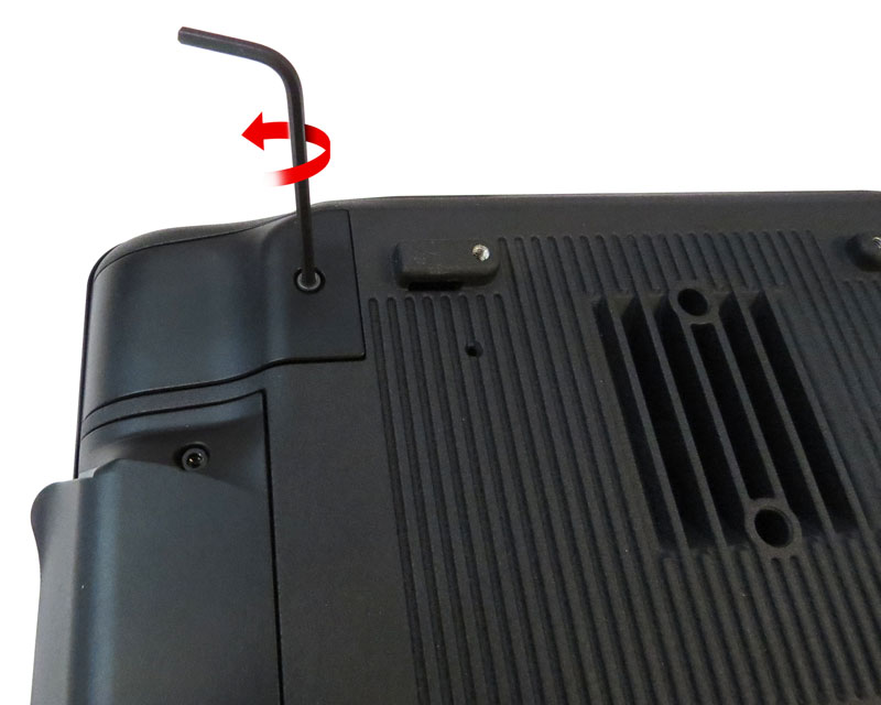 This image depicts the hex key removing the screw from the dummy cover, located on the back of the workstation.