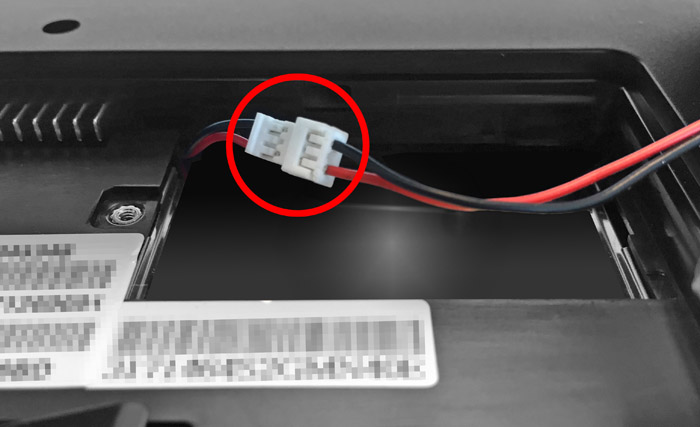 This figure shows the battery connector cable with the plastic connectors highlighted.