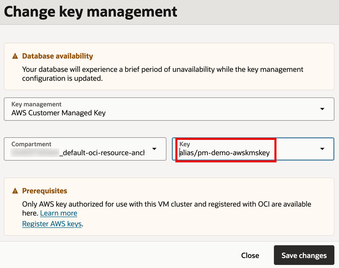 The image shows a “Change key management” screen where the database’s encryption key management is set to AWS Customer Managed Key. A warning indicates there may be a brief period of database unavailability while the key management configuration is updated. The highlighted field shows the selected AWS KMS key alias (alias/pm-demo-awskmskey) and a compartment selector, with a Save changes button to apply the update. It also notes prerequisites: only AWS keys authorized for the VM cluster and registered with OCI can be selected.