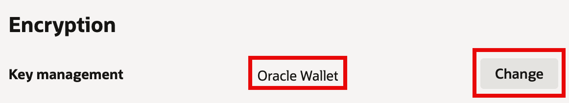 The image shows an Encryption settings section where Key management is currently set to Oracle Wallet (highlighted). On the right, a Change button (also highlighted) indicates you can switch the key management method. This is essentially the control point for changing how the database’s encryption keys are stored and managed.