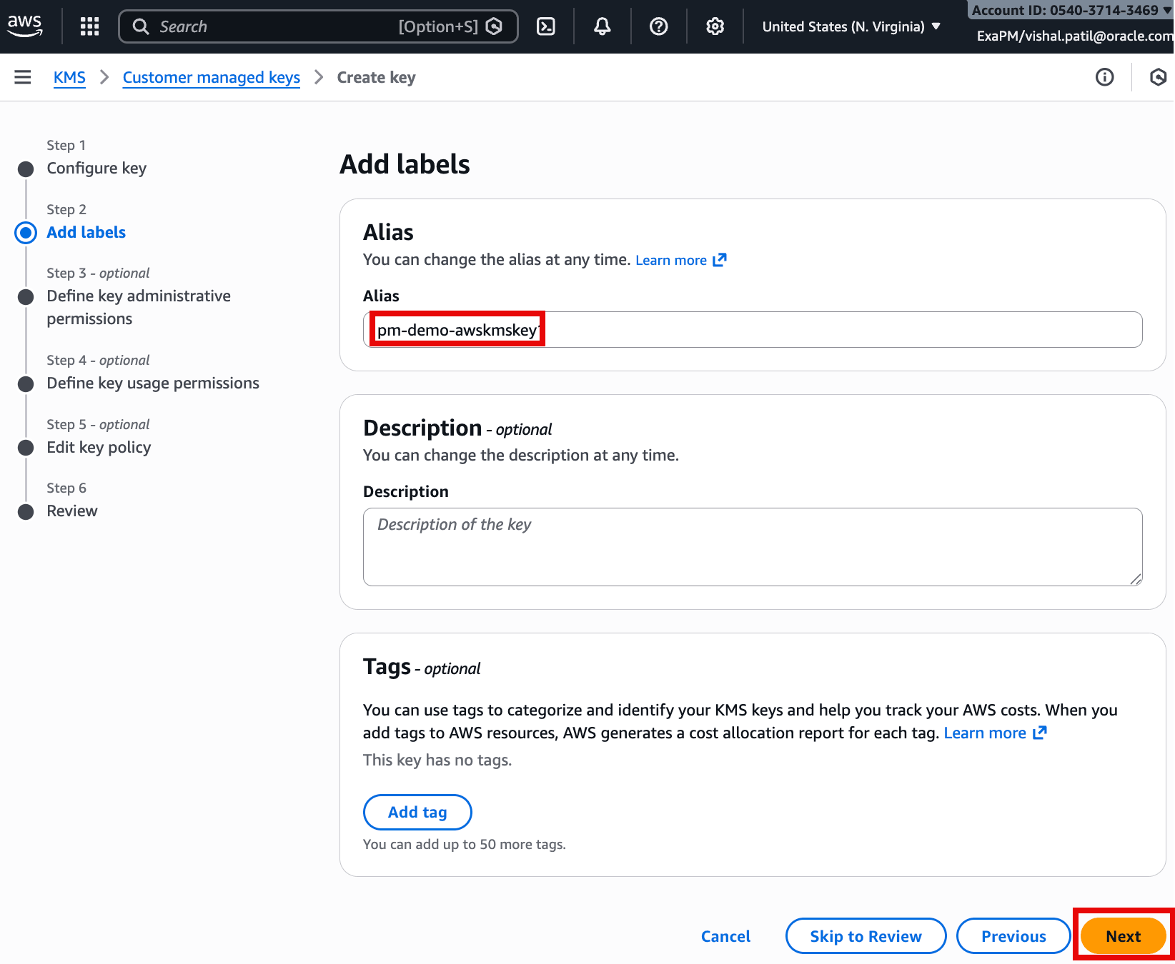 This screenshot is from the AWS KMS “Create key” wizard at Step 2: Add labels. The highlighted field shows the alias being set to pm-demo-awskmskey, which will be the friendly name used to reference the new customer-managed key. Optional sections for Description and Tags are available to document and categorize the key. The Next button (highlighted) continues to the remaining steps such as permissions, key policy, and review.