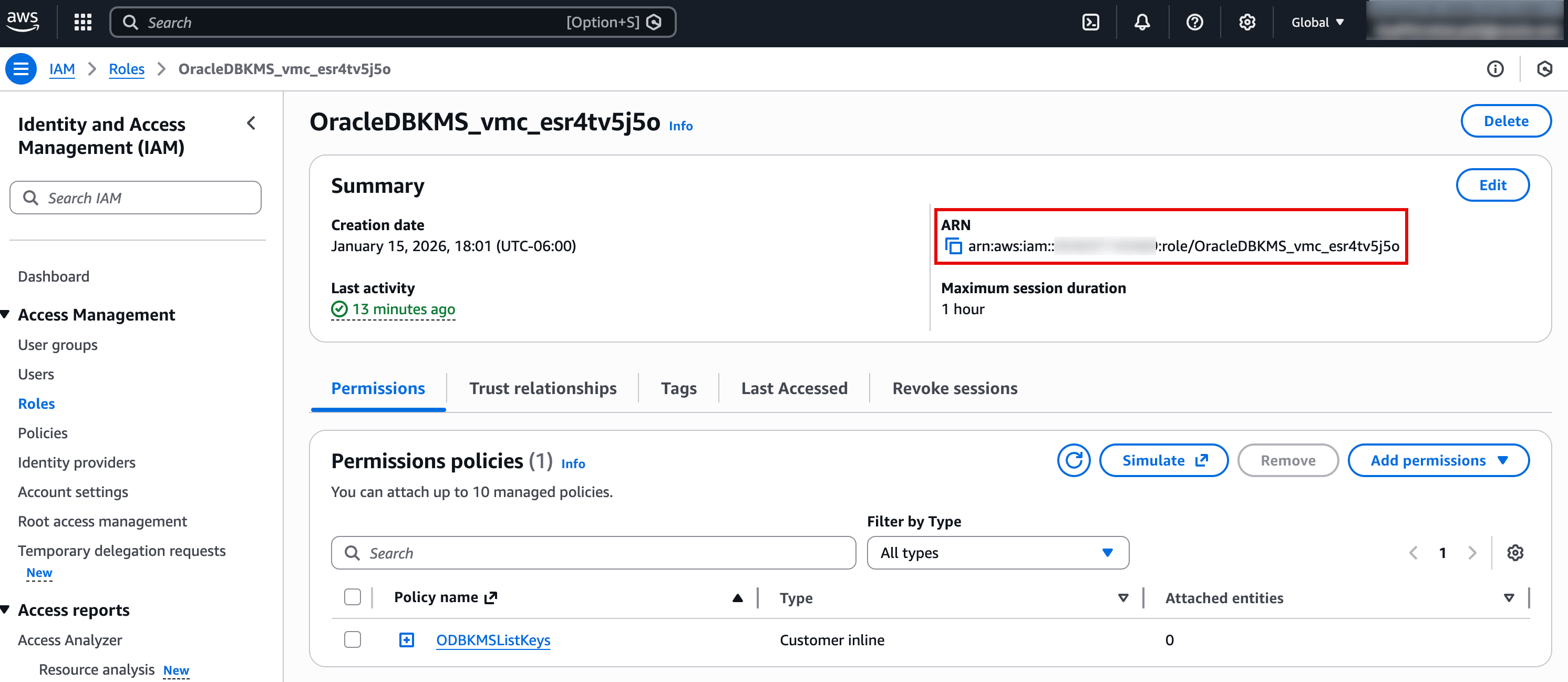 The screenshot shows the AWS IAM Role details page for a role named OracleDBKMS_vmc_esr4tv5j5o. The highlighted section displays the role’s ARN, which is the identifier you copy when associating this role with services (for example, enabling Oracle Database@AWS to access AWS KMS). The page also shows recent role activity and the role’s maximum session duration. In the Permissions policies section, an inline policy (e.g., ODB KMS ListKeys) is attached to define what the role is allowed to do.