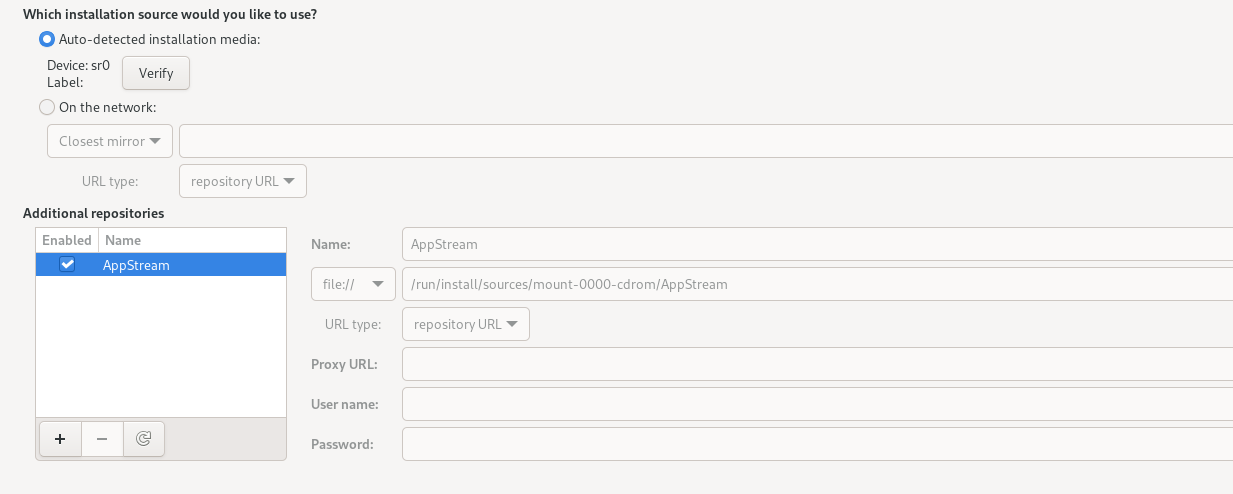 The image shows the Installation Source screen, which contains two options for selecting the installation source: Auto detected Installation Media and On the Network. Beside the auto detected installation media option is a Verify button. The On the Network option includes a drop-down list of network protocols, a text box to specify network location, and a drop-down list of URL types. Below the URL type drop-down list is a text box for additional repositories. The text box automatically lists available repositories but can also include other repositories you might want to add through buttons for adding, removing, and reloading repositories. These buttons are at the bottom of the text box. To the right of the text box are fields for name, location, proxy details, and user data. These fields provide information about a selected repository in the text box. This specific image applies to a case where the full ISO image is the installation source.